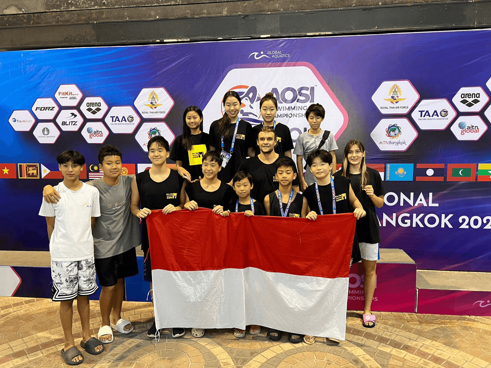 Team holding the Indonesian flag at the Bangkok International Swimming Championship, 2025