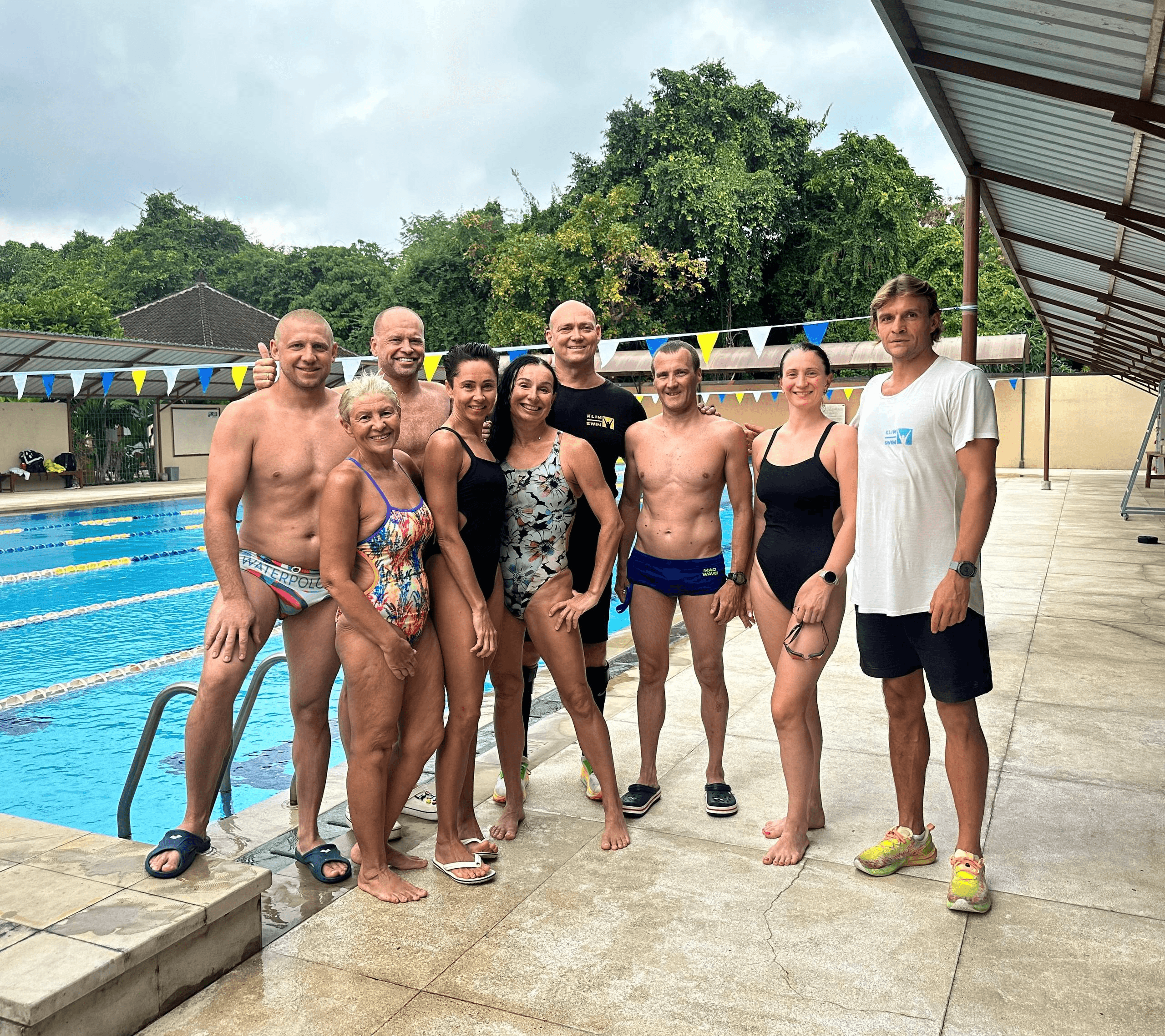 Group beside the pool at the KLIMSWIM Bali open-water camp, 2025