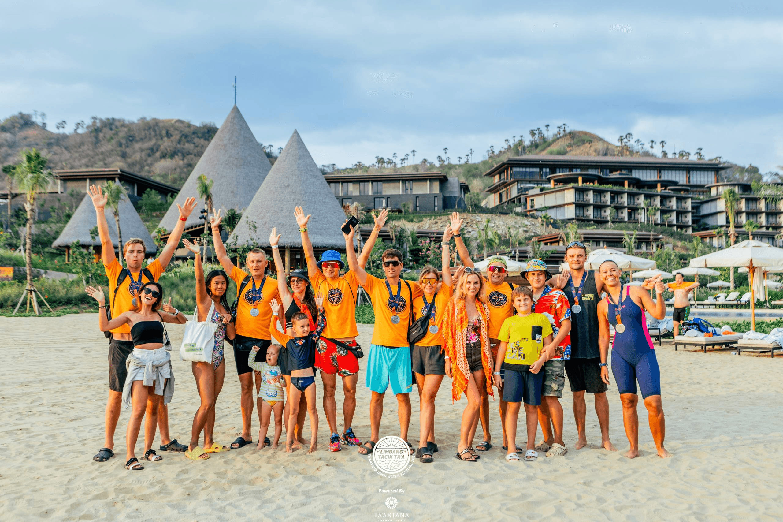 Open-water camp and race participants with medals on the beach in the Komodo Islands, 2024